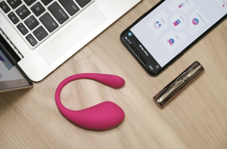 Don’t Trash It Yet: How to Recycle Old Sex Toys Responsibly a cell phone, a pen, and a laptop on a desk