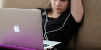 Stop Scrolling: How to Curate Your Adult Content Feed woman sitting on sofa with MacBook Air