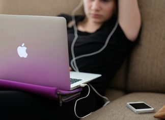 Stop Scrolling: How to Curate Your Adult Content Feed woman sitting on sofa with MacBook Air